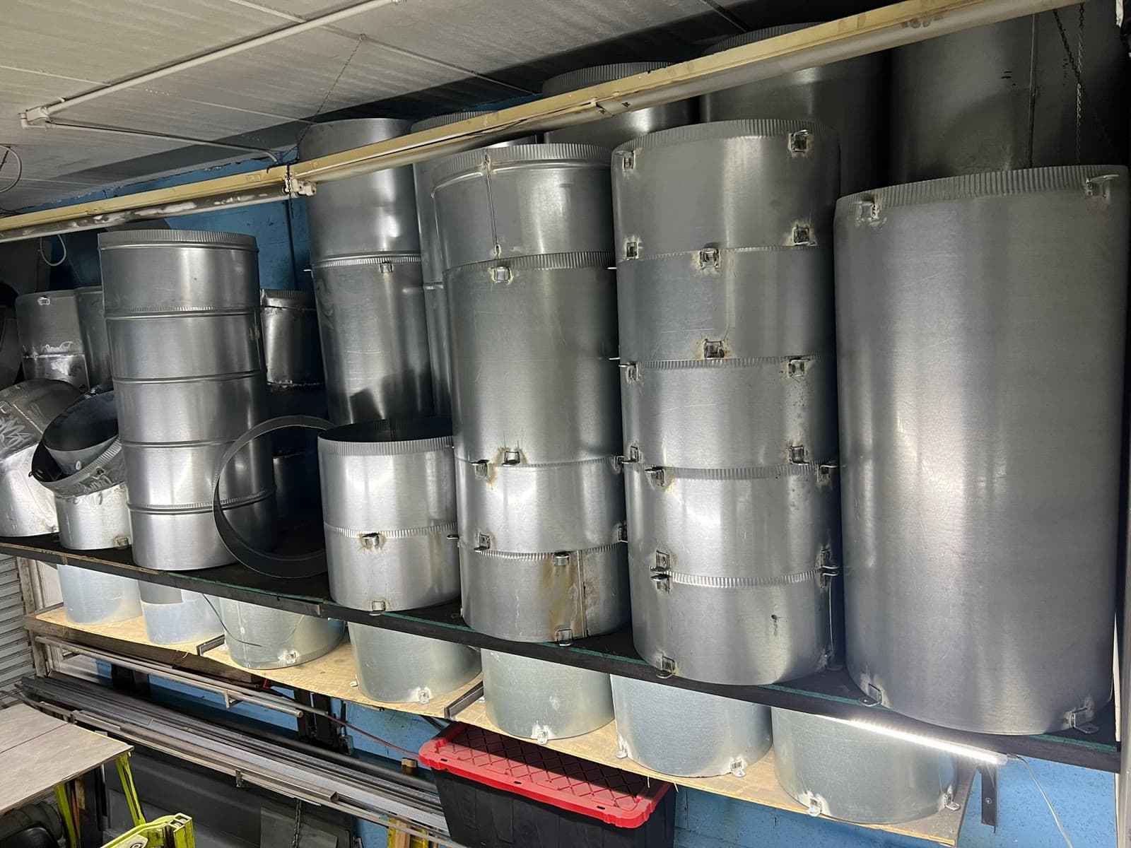 New trash chute sections stacked two shelves deep in the company's own shop