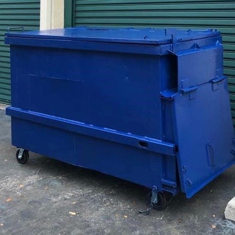 A blue two cubic yard waste container on casters