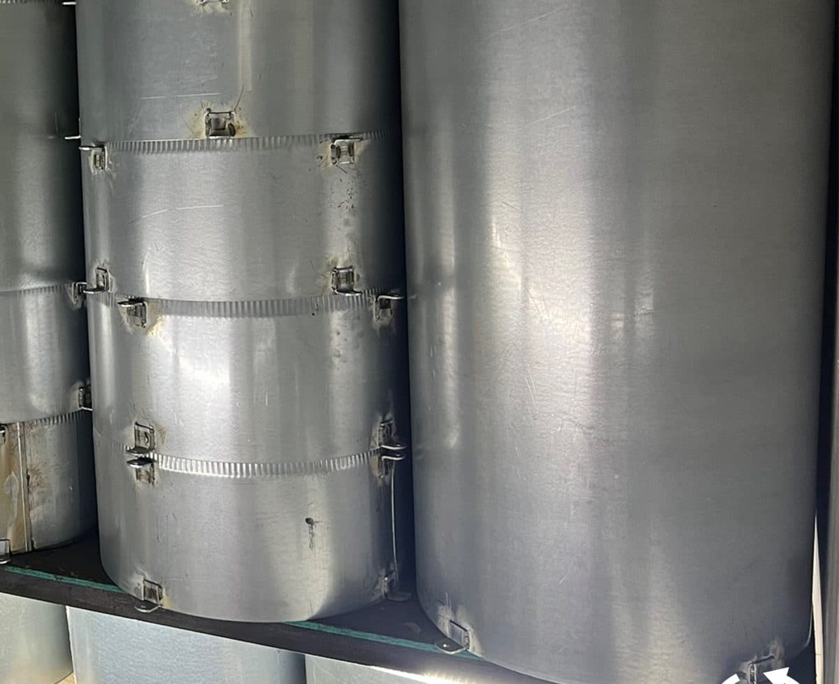 New steel trash chute sections stacked on the racking in the company's own shop